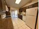 Kitchen boasts dark cabinets, granite counters, and white appliances at 1804 Discus Dr, Las Vegas, NV 89108