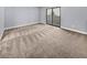 Spacious bedroom with plush carpeting and sliding glass door to balcony at 2080 Karen Ave # 49, Las Vegas, NV 89169