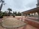 Covered patio, gravel yard, and mature palm trees at 2104 Fountain View Dr, Las Vegas, NV 89134