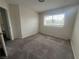 Bright bedroom with a window, carpet flooring, and access to a hallway at 2104 Fountain View Dr, Las Vegas, NV 89134