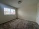 Well-lit bedroom featuring a window with blinds and carpeted floors at 2104 Fountain View Dr, Las Vegas, NV 89134