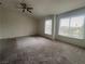 Spacious bedroom with carpeted floor, ceiling fan, and large windows at 2104 Fountain View Dr, Las Vegas, NV 89134