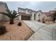 Two-story house with brown garage door and palm trees at 2104 Fountain View Dr, Las Vegas, NV 89134