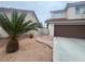 House with brown garage door and a palm tree at 2104 Fountain View Dr, Las Vegas, NV 89134