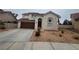 Two-story house with brown garage door and desert landscaping at 2104 Fountain View Dr, Las Vegas, NV 89134