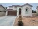 Two-story house with brown garage door and desert landscaping at 2104 Fountain View Dr, Las Vegas, NV 89134