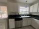 Kitchen with white cabinets, granite counters, and a double sink at 2104 Fountain View Dr, Las Vegas, NV 89134