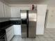 Kitchen with white cabinets, granite counters, and a refrigerator at 2104 Fountain View Dr, Las Vegas, NV 89134