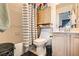 Bathroom with a tub, toilet and a wooden cabinet at 2137 Willowbury Dr # B, Las Vegas, NV 89108