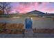 Front view of a single-story house with a blue gate at dusk at 2137 Willowbury Dr # B, Las Vegas, NV 89108