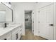 Modern bathroom with white cabinets, quartz countertops, and a walk-in shower at 2250 Xenia Ave, Pahrump, NV 89048