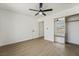 Bedroom with ceiling fan, mirrored closet, and wood-look flooring at 2250 Xenia Ave, Pahrump, NV 89048