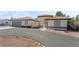 Single-story home with tile roof, attached garage, and landscaped front yard at 2250 Xenia Ave, Pahrump, NV 89048