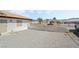 Gravel side yard with a view of neighboring houses at 2250 Xenia Ave, Pahrump, NV 89048