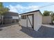 White storage shed with black trim and window at 2250 Xenia Ave, Pahrump, NV 89048