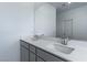 Double vanity with grey cabinets and white countertop at 230 Palisade Falls Ave, Henderson, NV 89015