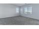 Bright bedroom with grey carpet and window views at 230 Palisade Falls Ave, Henderson, NV 89015