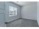 Spacious bedroom featuring a window and grey carpet at 230 Palisade Falls Ave, Henderson, NV 89015