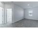 Spacious bedroom with grey carpet and access to another room at 230 Palisade Falls Ave, Henderson, NV 89015