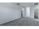 Bright bedroom with grey carpet and access to a closet at 230 Palisade Falls Ave, Henderson, NV 89015