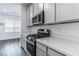 Modern kitchen features stainless steel appliances and white quartz countertops at 230 Palisade Falls Ave, Henderson, NV 89015