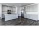 Modern kitchen with island, stainless steel appliances, and gray cabinets at 230 Palisade Falls Ave, Henderson, NV 89015