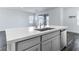 Kitchen island with white quartz countertop and gray cabinets at 230 Palisade Falls Ave, Henderson, NV 89015