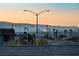 Scenic view of the neighborhood at sunset, with city skyline in the distance at 230 Palisade Falls Ave, Henderson, NV 89015