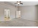 Bright bedroom featuring mirrored closet doors and carpeting at 2452 Sunup Dr, Las Vegas, NV 89134