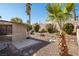 Landscaped backyard with gravel, plants, and patio at 3109 Siena Cir, Las Vegas, NV 89128