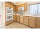 Modern kitchen with double oven, wood cabinets and tile flooring at 3109 Siena Cir, Las Vegas, NV 89128