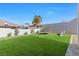 Landscaped backyard with artificial turf and playset at 311 Belfast St, Henderson, NV 89015