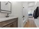 Bathroom with a vanity, bathtub, and view into bedroom at 311 Belfast St, Henderson, NV 89015