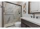 Bathroom with a walk-in shower and dark vanity at 311 Belfast St, Henderson, NV 89015