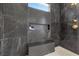 Elegant bathroom with a walk-in shower and marble tile at 311 Belfast St, Henderson, NV 89015