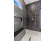 Modern bathroom with a large walk-in shower and marble tile at 311 Belfast St, Henderson, NV 89015