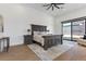 Main bedroom with king-size bed, sliding door to patio, and fireplace at 311 Belfast St, Henderson, NV 89015