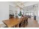 Elegant dining room with a large wooden table and modern chandelier at 311 Belfast St, Henderson, NV 89015