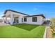 Modern home exterior with covered patio and artificial turf lawn at 311 Belfast St, Henderson, NV 89015