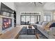 Bright living room features a stone fireplace and sliding glass doors to the patio at 311 Belfast St, Henderson, NV 89015