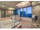 Luxurious bathroom with a large soaking tub, glass shower, and city views at 322 Karen Ave # 1001, Las Vegas, NV 89109