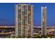 Night view of two modern highrise buildings with city lights in the background at 322 Karen Ave # 1001, Las Vegas, NV 89109