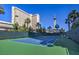 Well-maintained tennis court with green surface and surrounding fence at 322 Karen Ave # 1001, Las Vegas, NV 89109