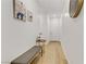 Bright and airy entryway with light wood floors, bench, and tasteful wall art at 355 Purple Sandpiper St, Las Vegas, NV 89138