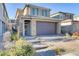 Two-story house with stone accents and a two-car garage at 355 Purple Sandpiper St, Las Vegas, NV 89138