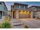 Two-story house with stone accents and a two-car garage at 355 Purple Sandpiper St, Las Vegas, NV 89138