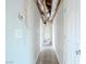 Long hallway with exposed ductwork and light beige walls at 3644 San Pascual Ave, Las Vegas, NV 89115