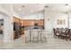 Bright kitchen with wood cabinets, granite countertops, and an island with seating at 3940 Colonial Field Ave, North Las Vegas, NV 89031