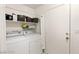 Convenient laundry room with washer, dryer, and storage shelves at 3940 Colonial Field Ave, North Las Vegas, NV 89031