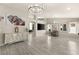 Open living room featuring gray floors, large windows and decorative art at 3940 Colonial Field Ave, North Las Vegas, NV 89031